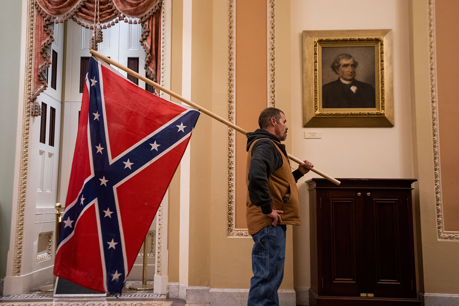 Trump-supporting rioter pictured carrying Confederate flag inside U.S. Capitol. January 6, 2021. 